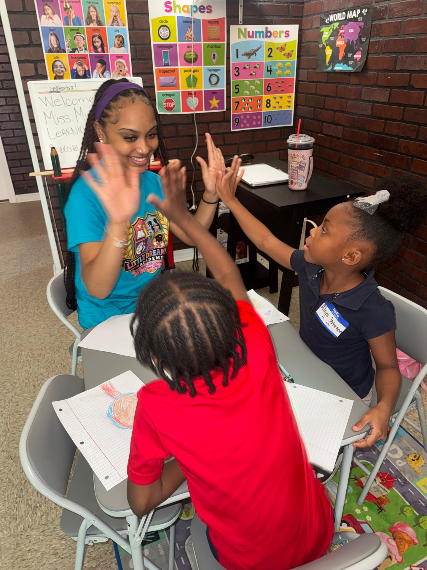Teacher celebrating a student with a high five
