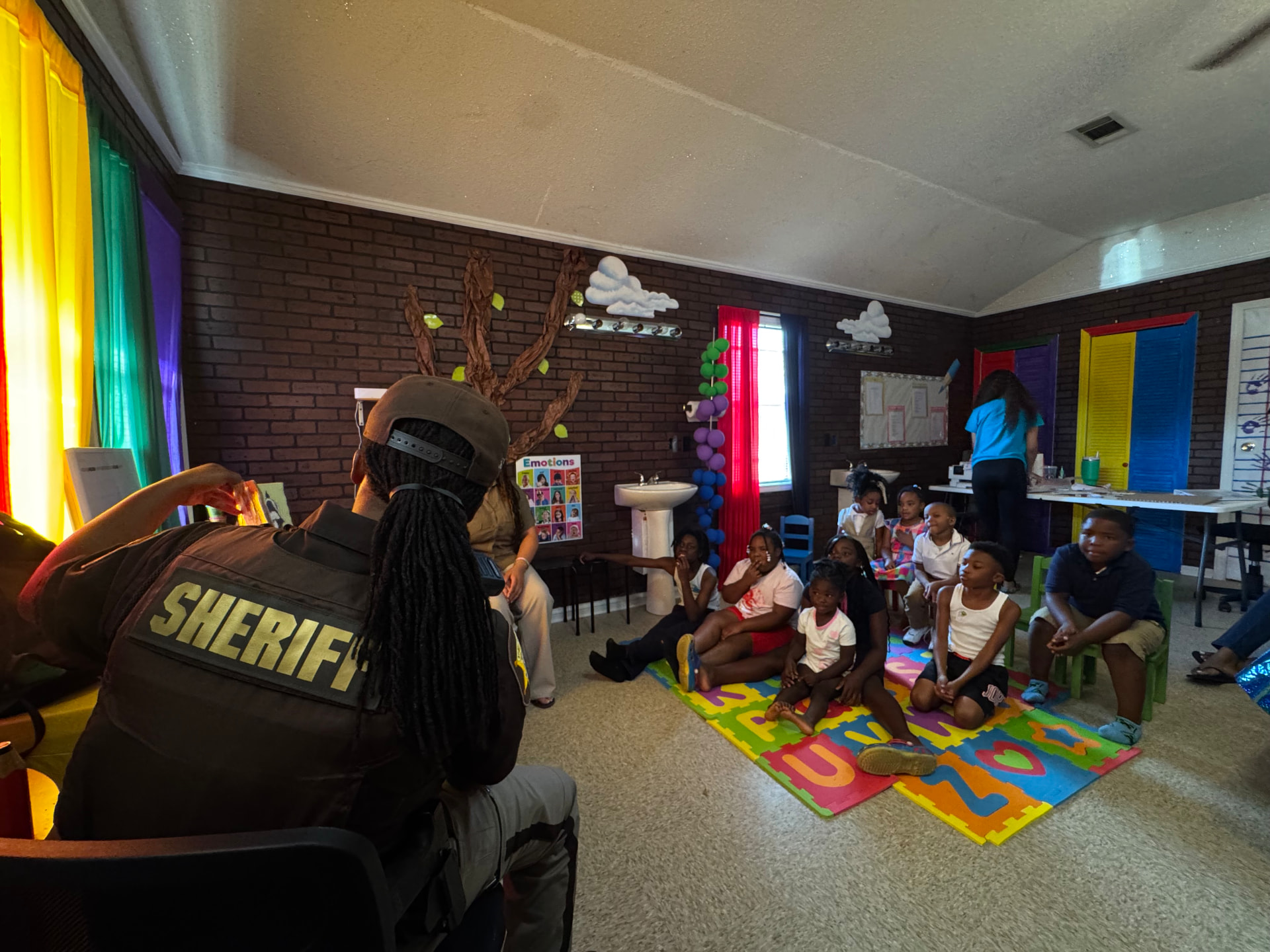 Community helpers visiting Little Dreamers Academy children in the classroom